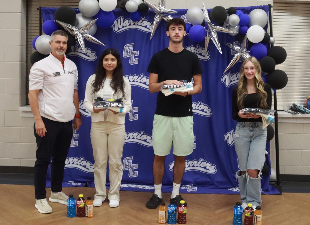 Coca Cola sponsor Nathan Medlock, Daniela Macias-Sanchez (volleyball), Dillon Taylor (cross country), and Kymberly Collins (cheerleading)