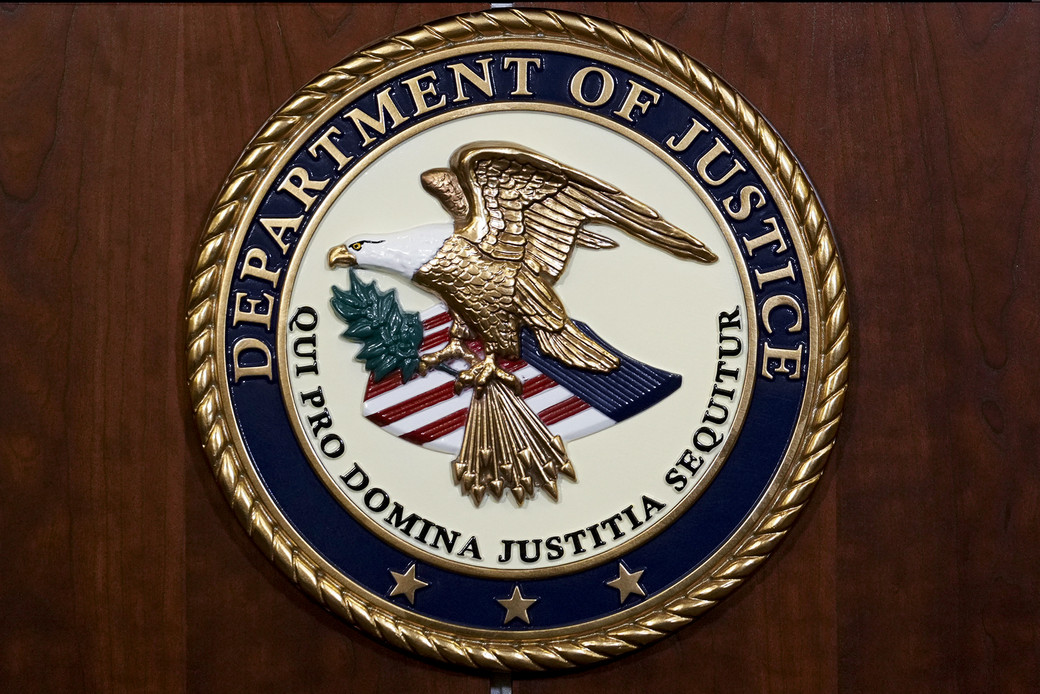 A picture of the seal of the Department of Justice.
